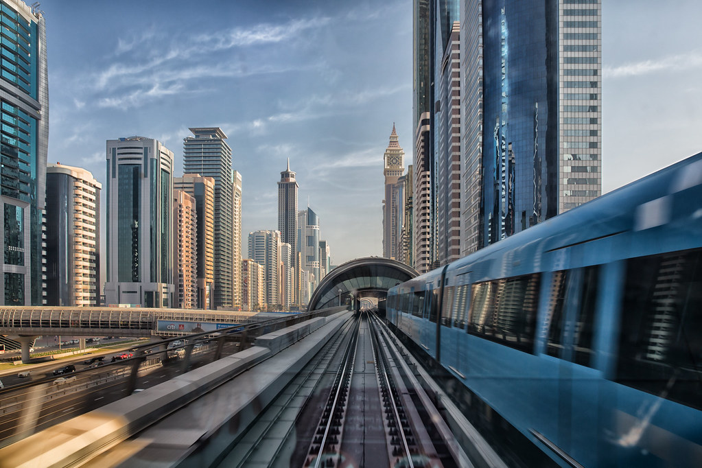 Dubai Metro running through the city with surrounding skyline